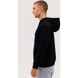 A black zip hood featuring a hood and a sleek design, displayed on a model from the side.