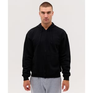 A black zip hoodie displayed on a model wearing grey sweatpants, featuring a hood and front pockets.