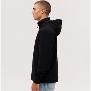 A man is wearing a black weather jacket with a hood, shown in profile against a plain background.