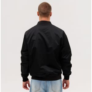 A black bomber jacket viewed from the back, featuring a simple design and ribbed cuffs.