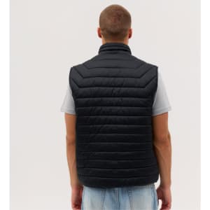 A black puffer vest with a quilted design, viewed from the back, worn by a person.