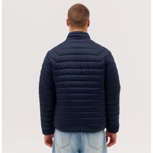 A puffer jacket in navy blue, featuring a quilted design, viewed from the back on a model.