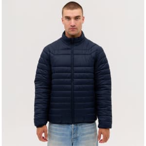 A man wearing a navy blue puffer jacket with a zip-front and a stand-up collar. The jacket features horizontal stitching.