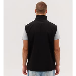 A black softshell vest is displayed, featuring a high collar and a sleek design, with a person wearing it from the back.