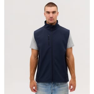 A man wearing a navy softshell vest over a grey T-shirt, standing against a neutral background.