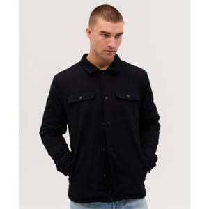 A black Studio Canvas Jacket with a collared neck and button closure, featuring two front pockets.