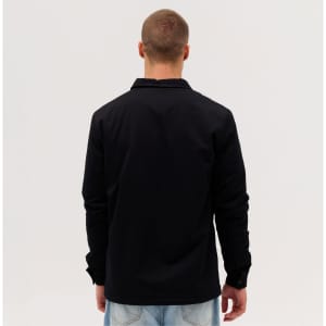A black Studio Canvas Jacket displayed from the back, featuring a simple design and long sleeves.