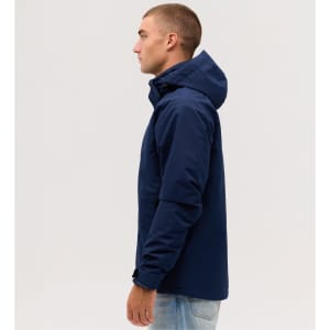 A navy blue utility jacket displayed on a model from the side, featuring a hood and a sleek design.