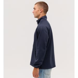 A navy Summit Bonded Jacket is displayed on a model, shown from the side. The jacket features a high collar and a logo.