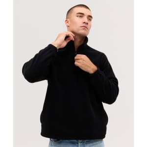 A model wearing a black Everest Polar Fleece 1/4 zip jumper, adjusting the collar. The garment has a logo.