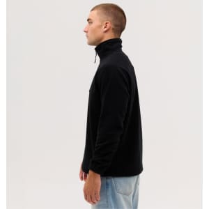 A side view of a black fleece 1/4 zip jumper, featuring a high collar and a relaxed fit. It has a logo on the chest.
