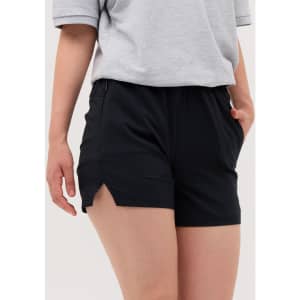 Black running shorts with side slits, worn with a grey top, featuring pockets and an elastic waistband.