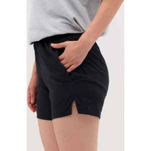 Black running shorts with side slits, featuring a relaxed fit and an elastic waistband.