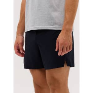 Navy running shorts with side slits, worn by a person in a grey t-shirt. The shorts have a minimalist design.