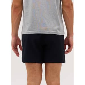 Men's running shorts in black, shown from the back with a grey top worn above. Features a logo.