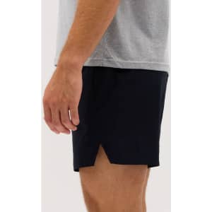 Running shorts in navy blue, featuring a split design and a lightweight fabric. A logo is visible on the shorts.