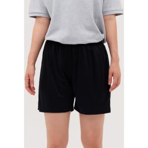 Black shorts displayed on a person, paired with a grey shirt, featuring an elastic waistband.