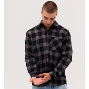 A man wearing a black and grey checkered flannel long sleeve shirt with a pocket, adjusting his cuff.