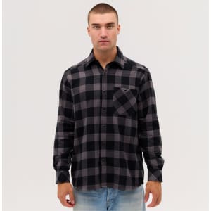 A long sleeve flannel shirt featuring a black and grey check pattern, with a pocket and a branded logo.