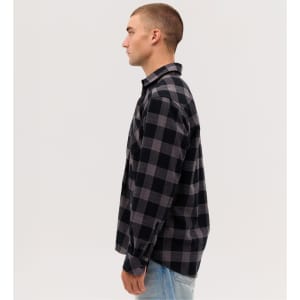 A long sleeve flannel shirt in black and grey check patterns, featuring a button-up design and a collar.