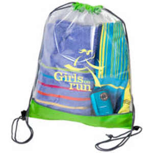 A clear PVC drawstring bag with a green base, containing towels and a portable device. It features a logo.