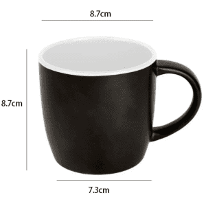 A black coffee mug with a white interior, featuring a handle and measurements indicated. It has a logo.