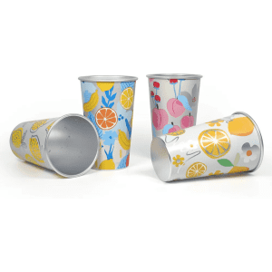 Colourful cups with fruit patterns, featuring designs in yellow, blue, and pink, with silver insides and a logo.