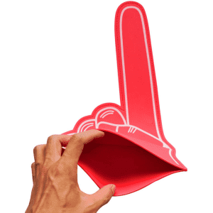 A red EVA foam supporter hand in the shape of a raised hand, held by a hand. It features a simple design with no text.