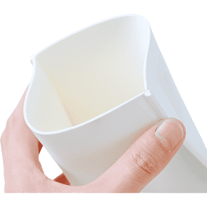 A hand holding a white EVA foam supporter, designed with a curved opening at the top. It has a branding logo.