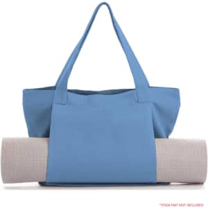 A blue canvas bag with two handles holds a rolled yoga mat, featuring a logo on the bag.