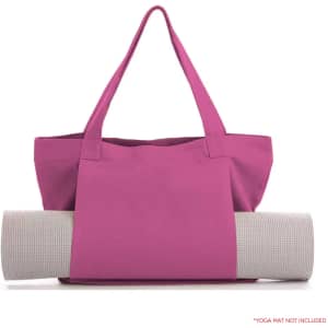 A pink canvas bag with two handles, holding a rolled-up yoga mat. The bag features a logo.