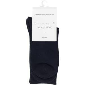 A pack of black bamboo socks, featuring a tag with care instructions and a logo.