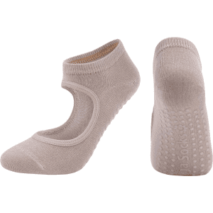 A pair of beige yoga socks with an open top and grip dots on the sole. The product features a logo.
