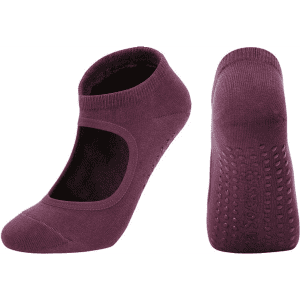 A pair of open-top yoga socks in a deep plum colour, featuring grip dots on the sole and a branded logo.