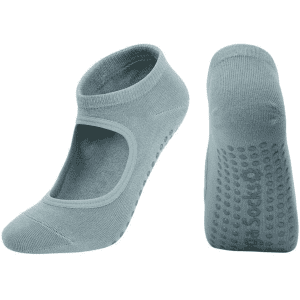 A pair of light blue open-top yoga socks featuring grip dots on the soles and a logo on one sock.