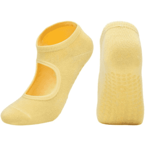 A pair of yellow open-top yoga socks with a non-slip grip on the soles. The socks have a logo on them.