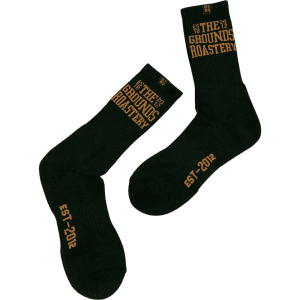 Black socks featuring a logo and text in gold, with a ribbed design and a crew length.