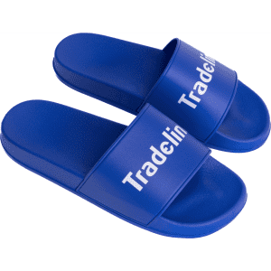 Blue PVC slides with a wide strap featuring a logo. The slides have a smooth, glossy finish.