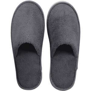 A pair of grey hotel slippers made from soft, plush material with an open-toe design.