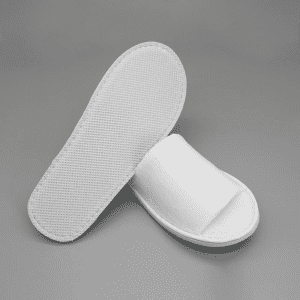 Open toe hotel slippers in white, featuring a textured sole and a simple design.