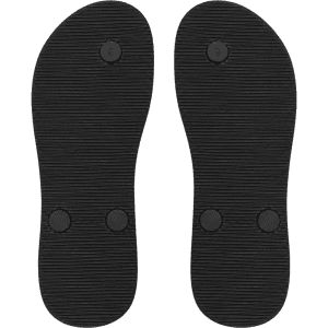 Black rubber soles of thongs with textured pattern and small circular buttons on the surface.