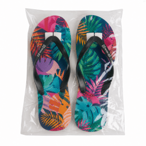 Full colour rubber thongs featuring a vibrant tropical leaf design with black straps, packaged in a clear bag.