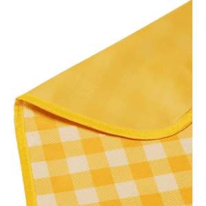 A yellow picnic blanket with a checkered pattern and a smooth edge. It features a branding logo in one corner.