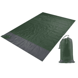 A green polyester picnic blanket laid out flat beside a matching pouch for storage.