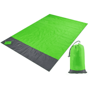 A bright green polyester picnic blanket laid out, accompanied by a matching pouch for storage. The pouch has a logo.