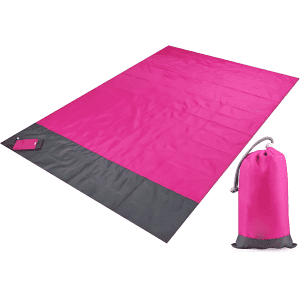 A pink polyester picnic blanket with a grey trim, accompanied by a matching pouch for storage.