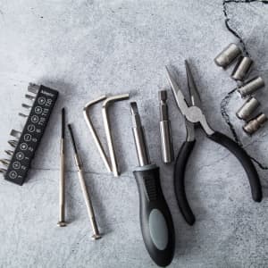 A 22-piece tool set featuring various metal tools, screwdrivers, pliers, and socket pieces in a sleek carry case.