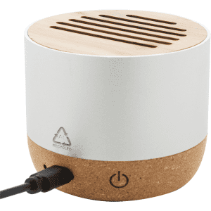 A cylindrical speaker featuring a bamboo top and a cork bottom, with a charging port visible. It has a recycling logo.