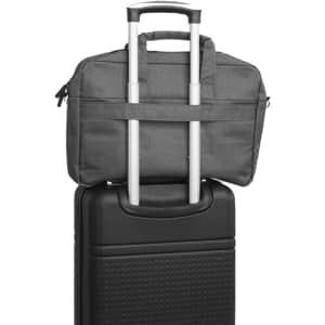 A grey laptop bag placed on top of a black suitcase, featuring a handle and zippers.