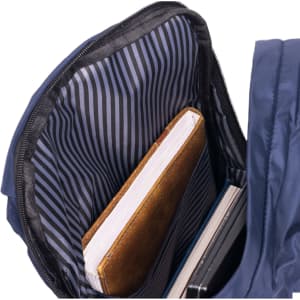 A navy backpack interior features striped lining with a brown notebook and two other items visible. It has a logo.